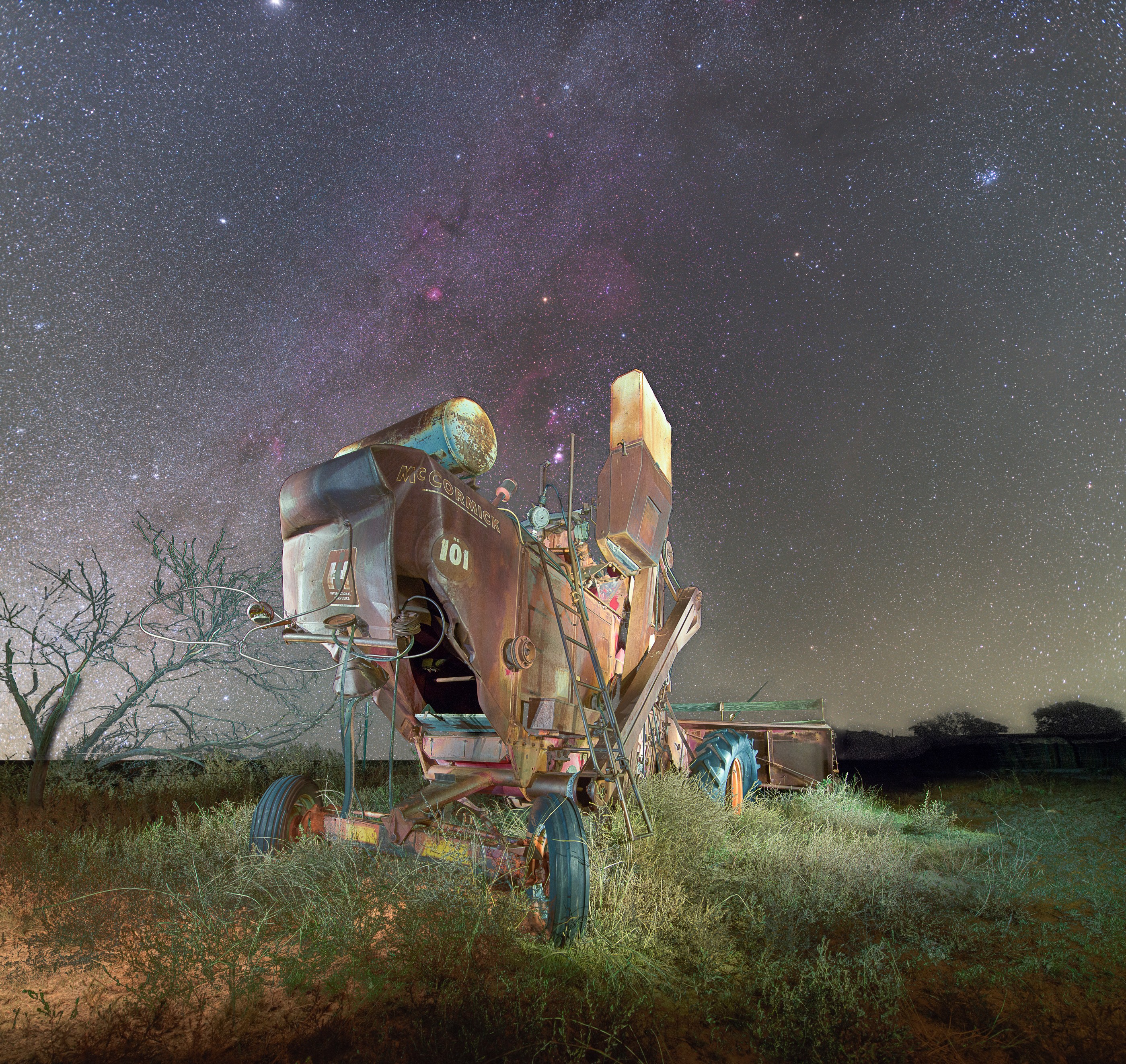 Weathered farm machinery beneath the stars at Black Mesa